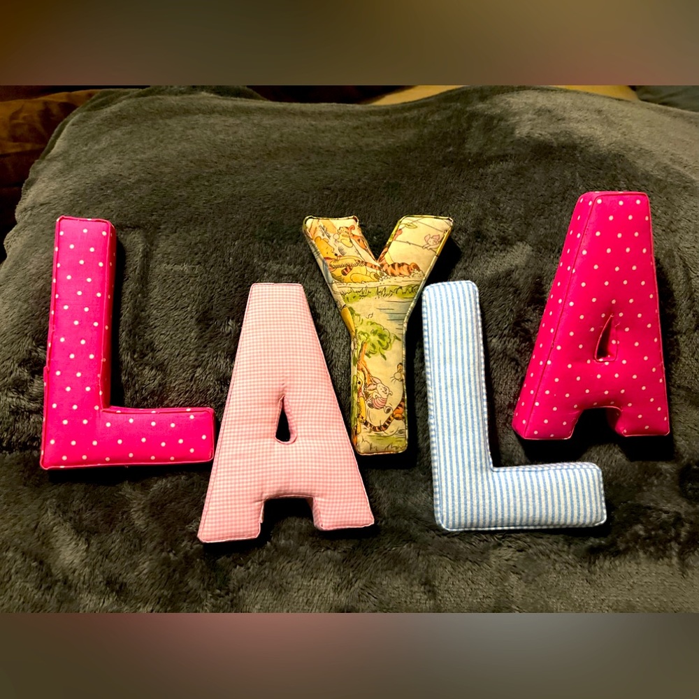 Fabric covered letters spells “LAYLA”